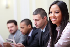 business professionals choosing real estate.  Asian loan rep in foreground